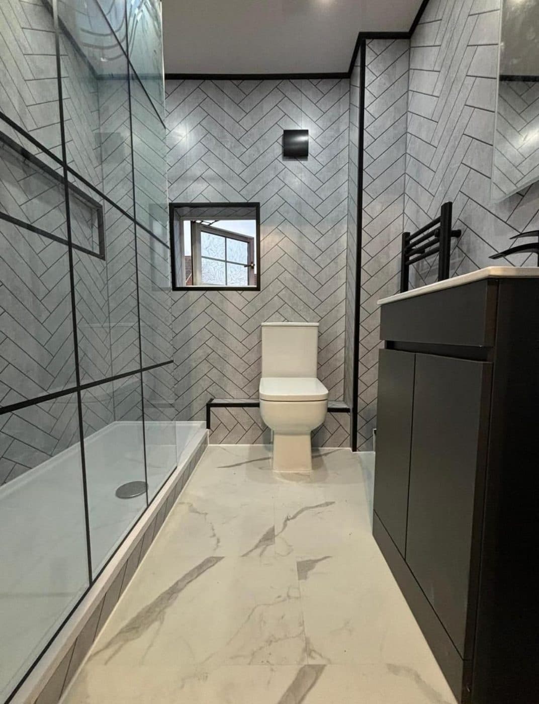 Spacious marble bathroom with a glass walk-in shower